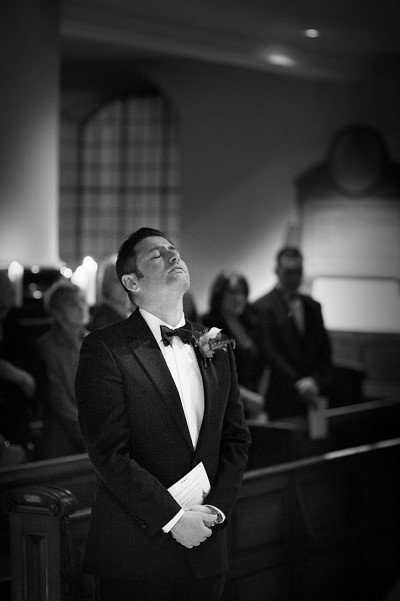 Groom prays at the alter before the wedding